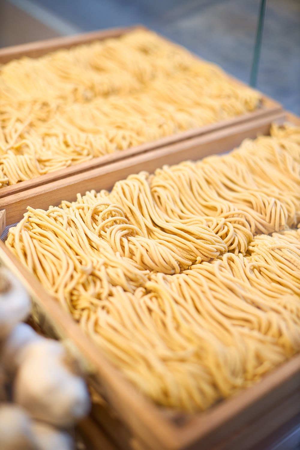 Trays of fresh bigoli, coiled in nests behind the counter